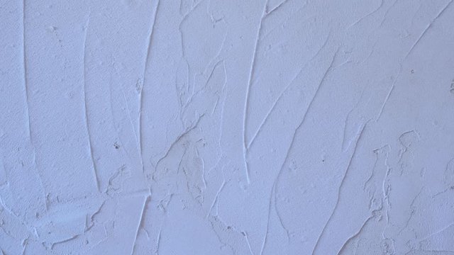 Putty wall aligning with plaster in room, renovation construction works and overhaul, closeup view. Finishing repairing works. Texture of gray cement wet plaster. Plastering coating wall surface.