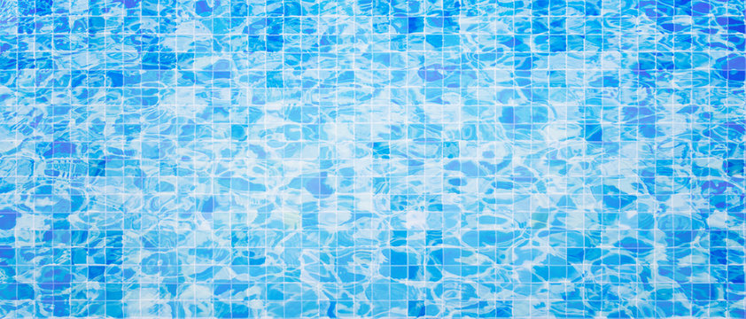 Abstract image of Blue water with ceramic tile mosaic in swimming pool.