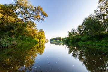 Fototapeta na wymiar Siberian River Ob surrounded by Trees in Early morning in Russia in sunny weather during summer