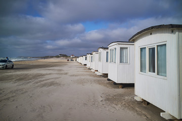 A row of beach white cabins