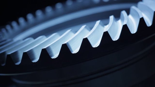Close-up of a rotating gear wheel in an engine &ndash; dark blue color
