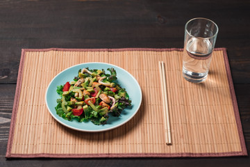 Top view - Salad with seafood on color plate
