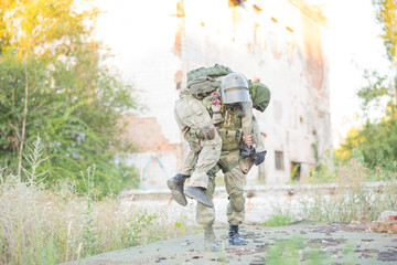 Military partner carries his wounded partner from shelling