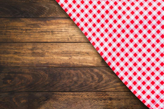 Red Checkered Table Cloth On Dark Wooden Table For Product Showing.