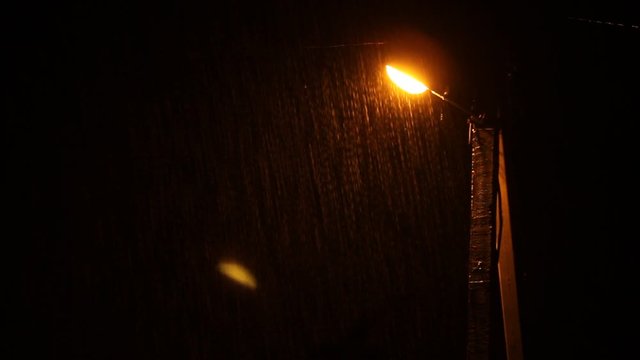 Wind and heavy rain over lamp post at night. Night scene 