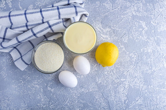 Step by step recipe. Cooking lemon pie or semolina cake. Step 1 Ingredients: semolina, sugar, eggs, lemon. Homemade food concept.