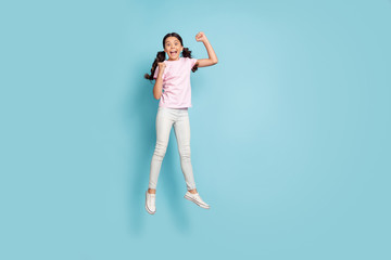Fototapeta na wymiar Full length body size view of her she nice attractive pretty overjoyed cheerful cheery lucky girl jumping having fun celebrating rejoicing great news isolated blue pastel color background