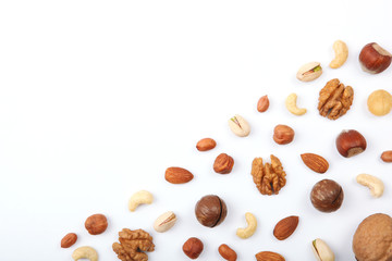 Fototapeta na wymiar Set of different nuts on a light background. 