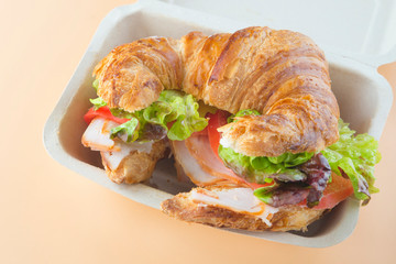 Sandwich of croissant of lettuce, tomato and smoked turkey