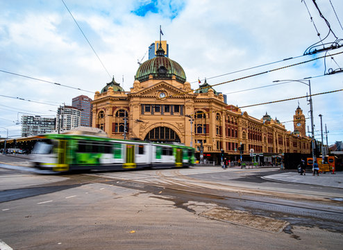 Flinders street station with tram passing in blur