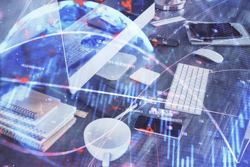 Double exposure of graph and financial info and work space with computer background. Concept of international online trading.