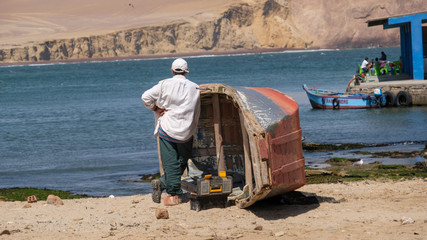 man working on boat looking into the distance