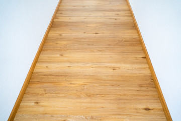 Home wood laminate flooring background. Light wooden textured interior house floor.