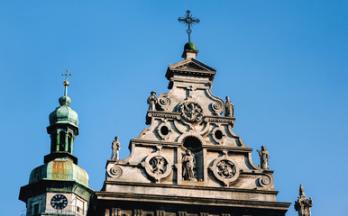 Roof of the Bernardine Church of St. Andrew with sculptures of Jesus, Mary and monks. Dome with a...