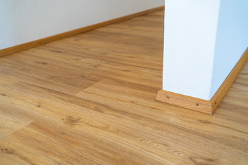 Home wood laminate flooring background. Light wooden textured interior house floor.