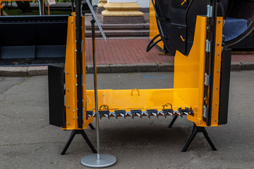 Abstract fragment of orange and black details of large equipment for agriculture. Heavy machinery abstract background..