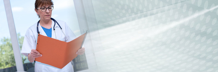 Female doctor holding a file; panoramic banner