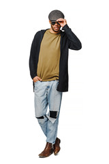 african-american young man in green t-shirt wearing sunglasses and cap over white background