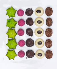 Filled delicious chocolate candy on white background.