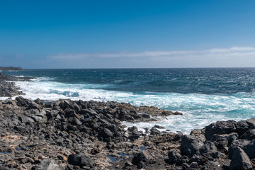 Sea and waves on the rocky shores of the volcanic island of Lanzarote