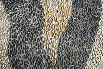 background made of a closeup of a wall with pebbles