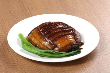 Close up of a popular Chinese Sichuan province cuisine steamed salty pork belly with pickled mustard leaves (Chinese: XianShaoBai)