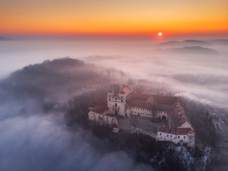 Fototapeta premium Drone aerial photo of Tyniec Abbey in mist near Krakow in Malopolska, Poland 