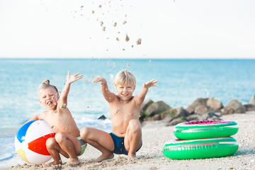 two kids having fun on the beach