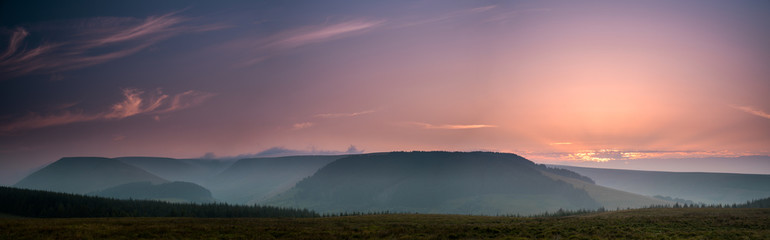 The colors of the sunrise. Panorama of Brecon Beacons National Park in Wales.