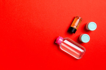 Cosmetics SPA branding mock-up, top view with copy space. set of tubes and jars of cream flat lay on colored background