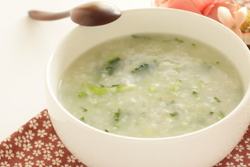 Chinese food, spinach and rice porridge in white bowl
