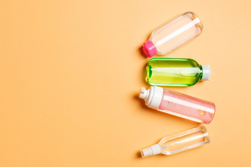 Cosmetics SPA branding mock-up, top view with copy space. set of tubes and jars of cream flat lay on colored background