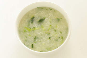 Chinese food, spinach and rice porridge in white bowl