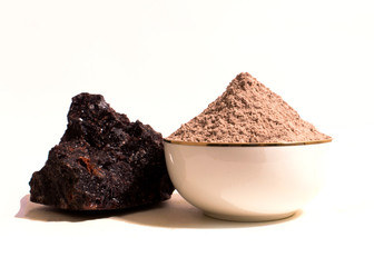 Black salt powder and a piece of black salt.