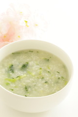 Chinese food, spinach and rice porridge in white bowl