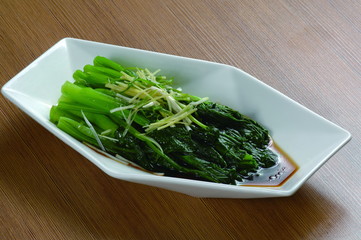 Close up of Hong Kong and Cantonese style  cuisine Boiled Chinese flowering cabbage Choy Sum with oyster sauce (Chinese:  BaiZhuoCaiXin)