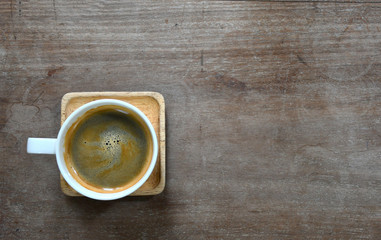 Coffee cup placed on a wooden board With copy space for text.