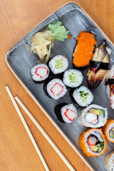 Fototapeta na wymiar Hawaii Japanese sushi dishes. Roll with maki and tuna, salmon, shrimp, crab and avocado. Various sushi Top view all you can eat menu. 