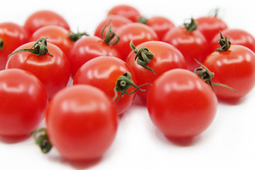 Cherry tomato branch. Cherry tomatoes isolated on a white background. Red tomatoes on a twig on a white background.	