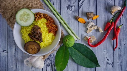 Nasi Kuning is rice cooked with turmeric and served with vegetables