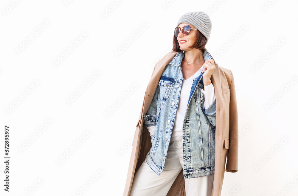 Wall mural Woman dressed in multilayered outfit for autumn days. Street fashion look.