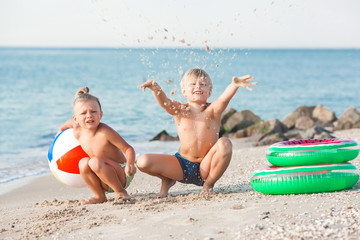 two kids having fun on the beach