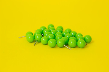 paper clips, pins and binders on yellow background