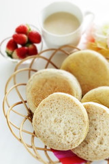 Home bakery, English muffin in bread basket for breakfast 