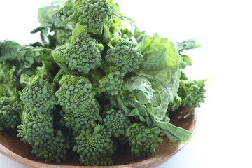 Japanese spring vegetable, nanohana green vegetable on wooden plate