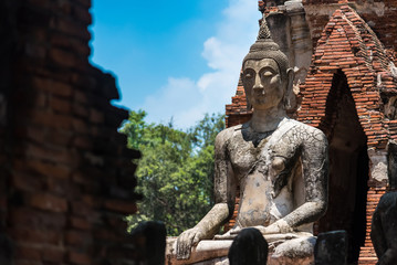 Ayutthaya, Thailand - June, 22, 2020 : Old Buddha statue sitting on brick in Wat Yai Chai Mongkhol temple, Ayutthaya, Thailand