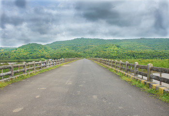 Fototapeta na wymiar A bridge to the hills. Monsoon overcast at Konkan, Maharashtra, Western India