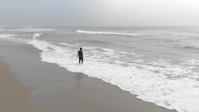 Lonely Indian Young Man Standing in the Beach
