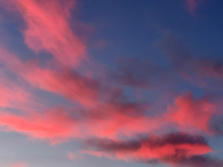 Beautiful vanilla sky with pink and red clouds over the roof