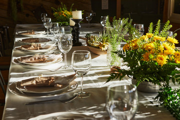 Laid table with cutlery and crockery in the sunset sunlight